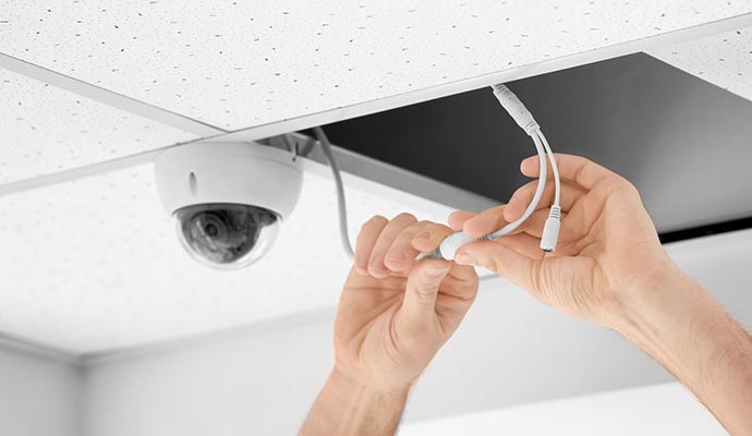A person installing digital security camera