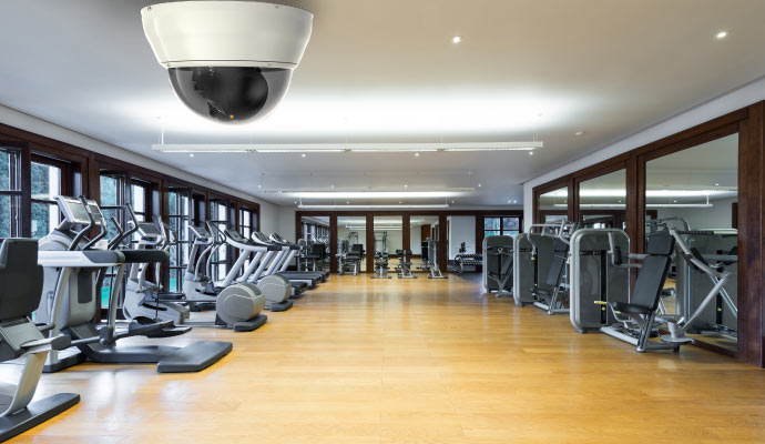 An installed security camera on gym center ceiling