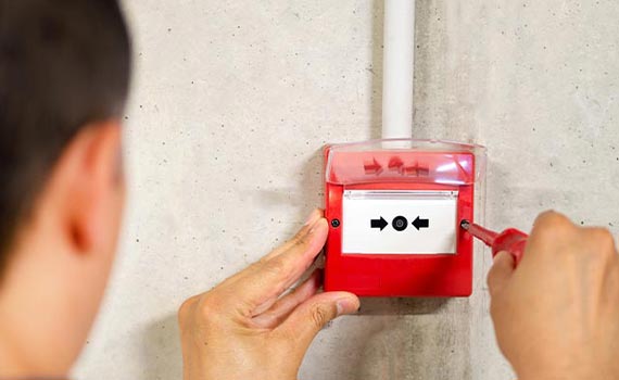 worker installing fire alarm system