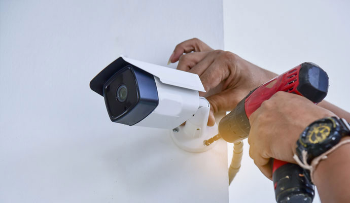 Expert installing security camera