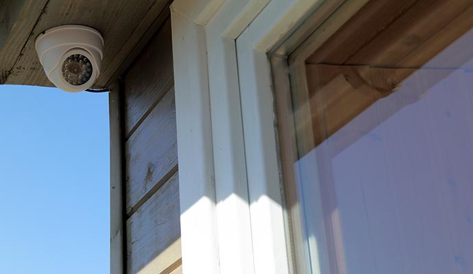 Outdoor security camera mounted on a house