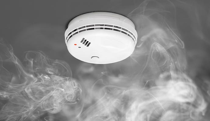 Smoke detector sensing smoke on a ceiling