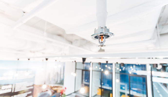 Fire sprinkler system mounted on the ceiling in a commercial space