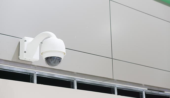 Outdoor security camera installed on building