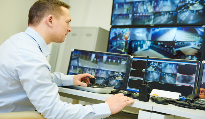 A person monitoring hidden camera footage