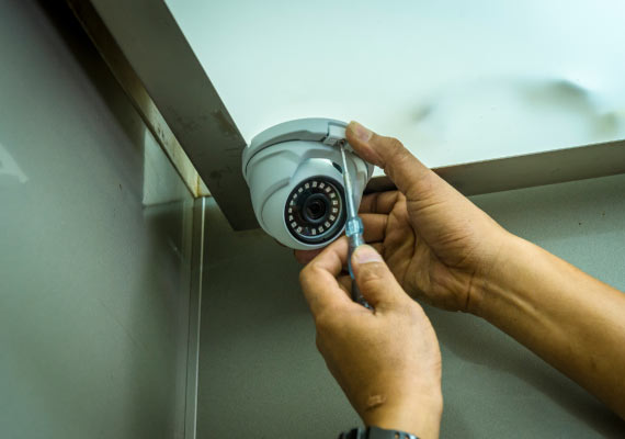 worker installing turret cameras