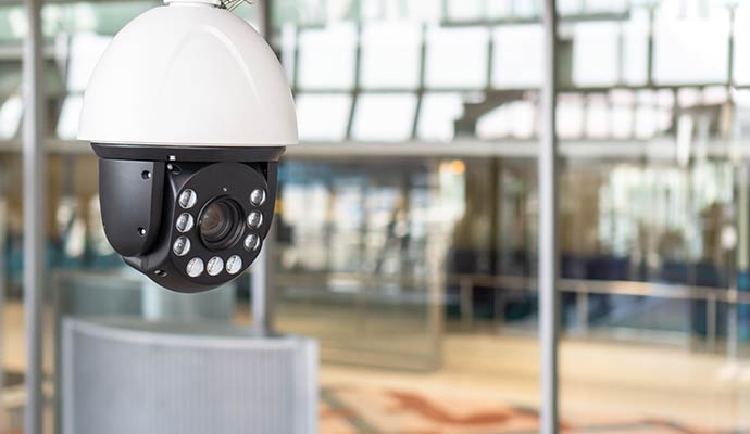 A high-definition IP PTZ security camera mounted indoors with a large lens and infrared LEDs for surveillance