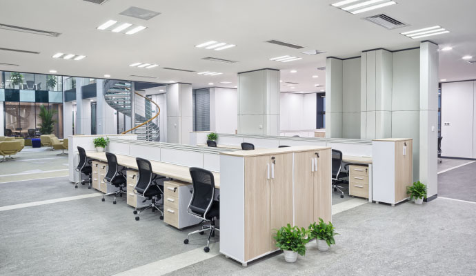 Modern commercial office workspace with open desk layout bright lighting and professional business interior