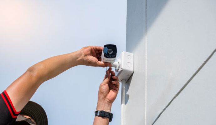 Professional installing an outdoor bullet camera
