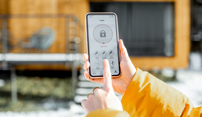 Person using security system app on smartphone