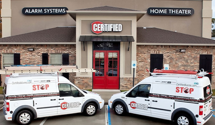 Security system company storefront with branded service vehicles parked outside commercial office location