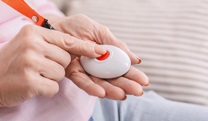 Senior pressing using emergency medical alert button