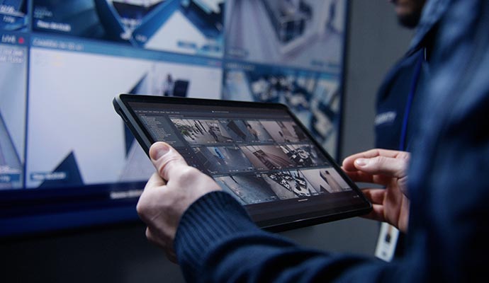 A business owner checking camera footage in his tab screen