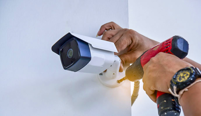 Technician installing security camera