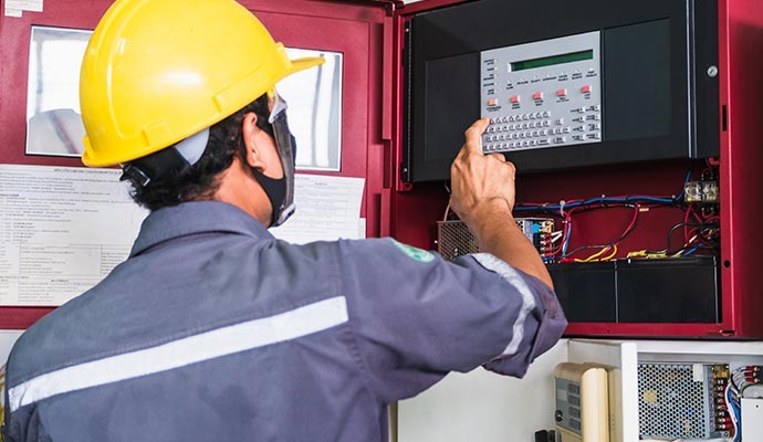 Technician monitoring fire alarm